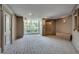 Bright condominium foyer with elevator, carpet, and view of foliage at 3203 Lenox Ne Rd # 22, Atlanta, GA 30324