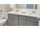 This is a bathroom with a double vanity, gray cabinets and quartz countertops at 3794 Jack Vernon Cir, Powder Springs, GA 30127