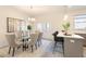 Bright dining room with modern lighting, a glass table, and a kitchen island with barstool seating at 3794 Jack Vernon Cir, Powder Springs, GA 30127