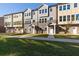 View of new townhomes featuring stone accents and neutral color palettes on a sunny day at 3794 Jack Vernon Cir, Powder Springs, GA 30127