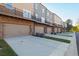 Row of townhomes featuring attached garages, private balconies, and well-maintained landscaping at 3794 Jack Vernon Cir, Powder Springs, GA 30127