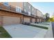 Townhome exteriors showing brick facade and garages and individual balconies at 3794 Jack Vernon Cir, Powder Springs, GA 30127