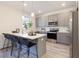 Well-equipped kitchen with stainless steel appliances, a center island with barstool seating, and gray cabinetry at 3794 Jack Vernon Cir, Powder Springs, GA 30127