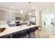 Bright, open kitchen featuring stainless steel appliances, quartz countertops, and a spacious island with barstools at 3794 Jack Vernon Cir, Powder Springs, GA 30127