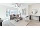 Bright living room featuring hardwood floors, large windows, and modern furnishings at 3794 Jack Vernon Cir, Powder Springs, GA 30127