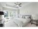 Bright main bedroom with a ceiling fan, a large window view and a gray headboard at 3794 Jack Vernon Cir, Powder Springs, GA 30127