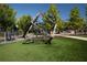 Community playground with geometric climbing structure, turfed ground covering, and pedestrian walkways at 3794 Jack Vernon Cir, Powder Springs, GA 30127
