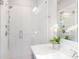Modern shower with glass doors, white tile, and a rainfall shower head at 3794 Jack Vernon Cir, Powder Springs, GA 30127