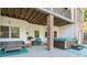 Covered back patio with a hot tub, seating area, and brick pillars at 6740 Mountain Lake Ln, Cumming, GA 30028
