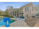 Expansive backyard with brick patio, pool, hot tub, and multi-level porch perfect for entertaining at 6740 Mountain Lake Ln, Cumming, GA 30028