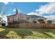Backyard view with tiered landscaping, decorative fencing, mature trees, and a partial home view at 6740 Mountain Lake Ln, Cumming, GA 30028