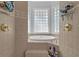 Luxurious bathroom showcasing a soaking tub nestled between two tiled showers at 6740 Mountain Lake Ln, Cumming, GA 30028