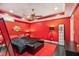 Bold bedroom featuring an all-red color scheme and dark furniture at 6740 Mountain Lake Ln, Cumming, GA 30028