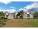 Spacious brick home with well-manicured lawn and mature trees, offering a picturesque setting at 6740 Mountain Lake Ln, Cumming, GA 30028