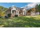 Brick home with an expansive lawn and mature trees, offering curb appeal and a serene outdoor space at 6740 Mountain Lake Ln, Cumming, GA 30028