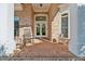 Charming brick front porch with rocking chair and double-door entry at 6740 Mountain Lake Ln, Cumming, GA 30028