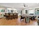 Well-lit game room featuring a sleek bar, ceiling fan, and multiple game tables for entertaining at 6740 Mountain Lake Ln, Cumming, GA 30028