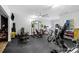 Spacious home gym featuring weights, weight rack, bicycle, punching bag, and ceiling fan at 6740 Mountain Lake Ln, Cumming, GA 30028