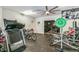 Large home gym with treadmill, weight machines, bicycle, and ceiling fan at 6740 Mountain Lake Ln, Cumming, GA 30028