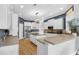 Stylish kitchen with stainless steel appliances, white cabinetry, and wood floors at 6740 Mountain Lake Ln, Cumming, GA 30028