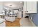 Bright kitchen with white cabinets, stainless steel appliances, island, and hardwood floors at 6740 Mountain Lake Ln, Cumming, GA 30028