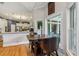Open kitchen area with a breakfast table, hardwood floors, and natural light from large windows at 6740 Mountain Lake Ln, Cumming, GA 30028