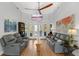 Bright living room featuring hardwood floors, gray sofas and large windows at 6740 Mountain Lake Ln, Cumming, GA 30028