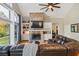 Bright living room featuring brick fireplace, built-in shelving, and ample seating at 6740 Mountain Lake Ln, Cumming, GA 30028