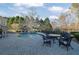 Backyard pool with a stone patio, surrounded by lush landscaping and mature trees at 6740 Mountain Lake Ln, Cumming, GA 30028