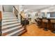 Elegant staircase leading to the lower level with a wet bar and additional seating at 6740 Mountain Lake Ln, Cumming, GA 30028