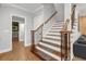 Elegant stairway with wooden banister and decorative iron spindles at 6740 Mountain Lake Ln, Cumming, GA 30028