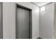 Hallway view of gray unit door with silver numbers and modern lighting at 845 Spring Nw St # 127, Atlanta, GA 30308