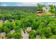 Aerial view of the home and surrounding lush trees, showing property lines at 10490 Cranchester Way, Alpharetta, GA 30022