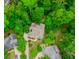 Aerial of the property showcasing lush tree coverage on a spacious lot at 10490 Cranchester Way, Alpharetta, GA 30022
