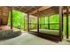 Charming back porch with a brick patio and lush green surroundings at 10490 Cranchester Way, Alpharetta, GA 30022