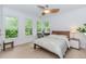 Charming bedroom features hardwood floors, natural light, a ceiling fan, and a stylish desk at 10490 Cranchester Way, Alpharetta, GA 30022