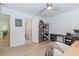 Bright bedroom boasts light hardwood floors, a ceiling fan, and space for a desk and shelving at 10490 Cranchester Way, Alpharetta, GA 30022