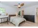 Charming bedroom features hardwood floors, natural light, a ceiling fan, and modern decor at 10490 Cranchester Way, Alpharetta, GA 30022
