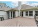 Spacious wooden deck with white siding and black metal railing, offering outdoor living at 10490 Cranchester Way, Alpharetta, GA 30022
