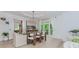 Dining room with light hardwood floors and modern chairs, fixture and accents at 10490 Cranchester Way, Alpharetta, GA 30022