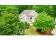 Traditional home with a manicured lawn and arched entryway at 10490 Cranchester Way, Alpharetta, GA 30022