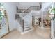 Bright foyer with modern staircase, iron railings, and views into the adjacent dining area; light hardwood flooring at 10490 Cranchester Way, Alpharetta, GA 30022