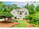 Charming two-story home boasts lush landscaping, a welcoming front porch, and a classic architectural design at 10490 Cranchester Way, Alpharetta, GA 30022