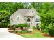 Inviting two-story facade with mature trees, well-maintained lawn, and a welcoming entrance with a charming walkway at 10490 Cranchester Way, Alpharetta, GA 30022
