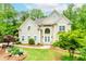 Elegant home with manicured lawn, bench, and double door entrance with beautiful decorations at 10490 Cranchester Way, Alpharetta, GA 30022