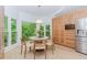 Bright kitchen with an adjacent eat-in nook with stainless steel appliances and large wooded view at 10490 Cranchester Way, Alpharetta, GA 30022