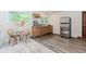 Open kitchenette featuring wood cabinets, a stainless steel refrigerator, and a cozy dining area at 10490 Cranchester Way, Alpharetta, GA 30022