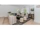 Comfortable living room with modern furnishings, including a sofa, chairs, and a stylish black coffee table on an oriental rug at 10490 Cranchester Way, Alpharetta, GA 30022