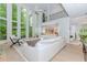 Bright living room boasts two-story windows, hardwood floors, and neutral decor at 10490 Cranchester Way, Alpharetta, GA 30022