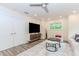 Stylish living room featuring a large TV, a comfortable couch, and a window with greenery views at 10490 Cranchester Way, Alpharetta, GA 30022